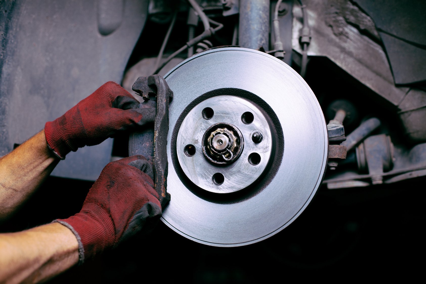 A mechanics changing a brake pad